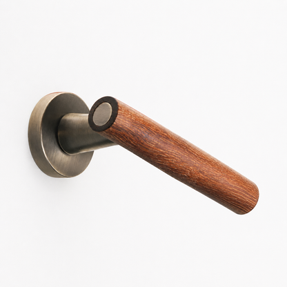 Magnetic door lock handle close-up with antique grey round plate and dark wood lever